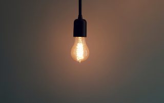 closeup shot of illuminated light bulbs hanging from a ceiling